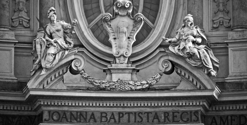 grayscale photo of a concrete statue